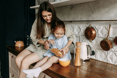 Mother and son on table at home