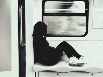 Rear view of man sitting in train