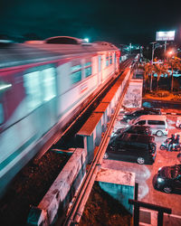 Blurred motion of train on railway bridge at night