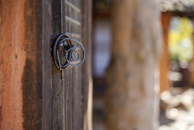 Metallic door knocker tied with spiral wire
