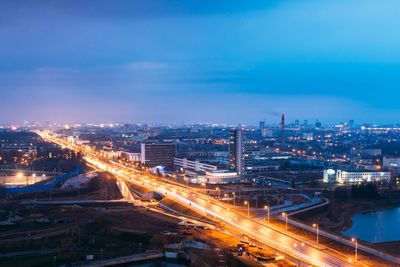 High angle view of illuminated cityscape against sky at night