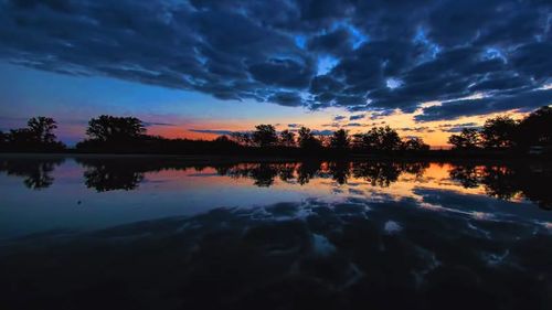 Reflection of clouds in lake at sunset