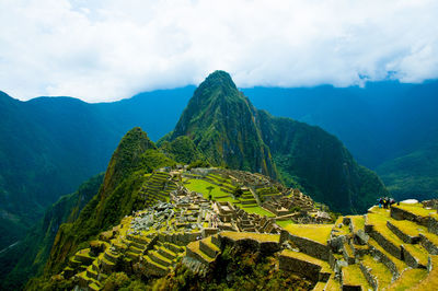 Scenic view of mountains against cloudy sky