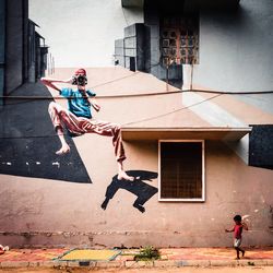 People jumping on street against building in city