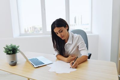 Young businesswoman working at office