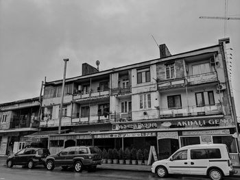 Cars on street against buildings in city