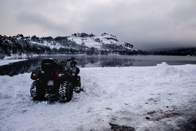 View of vehicle on snow covered mountain against sky