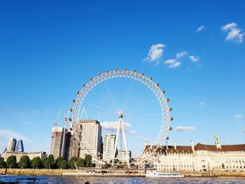 Ferris wheel in city against sky