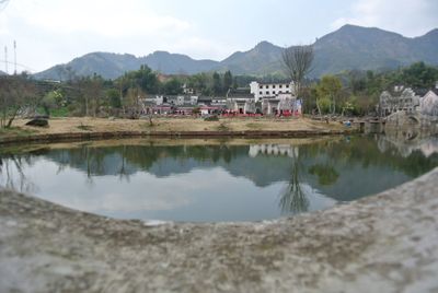 Scenic view of river and mountains against sky