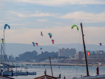 Panoramic view of sea and cityscape against sky