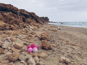 View of rocks on beach against sky