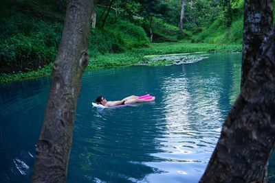 Side view of man swimming in lake