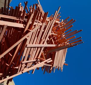 Low angle view of construction site against clear blue sky