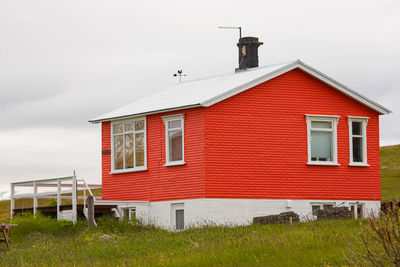 Small red isolated house on icelandic island. simple construction.