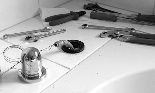 Close-up of work tools on tiled floor