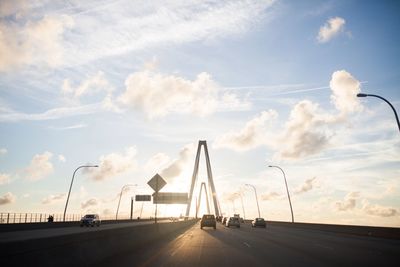 Vehicles on arthur ravenel jr bridge against sky