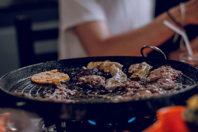 Close-up of meat cooking on pan