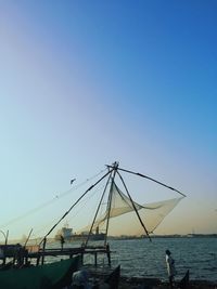 Sailboats on sea against clear blue sky