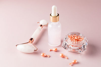 Transparent bottle of cosmetic or essential oil, aromatherapy with natural cosmetics. 	
