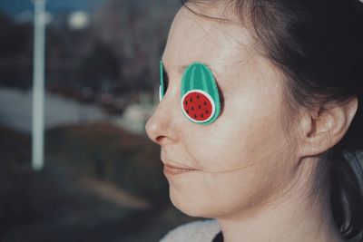 Close-up of woman wearing props on eyes