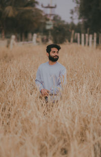 Young man standing on field