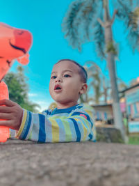 Portrait of cute boy looking away outdoors