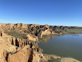 Scenic view of rock formations against clear blue sky