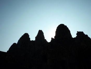 Low angle view of rocks against blue sky