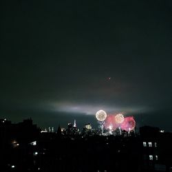 Low angle view of firework display at night