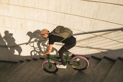 High angle view of man cycling on staircase