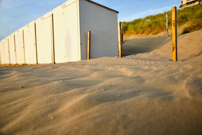 Surface level of sand at the beach against blue sky