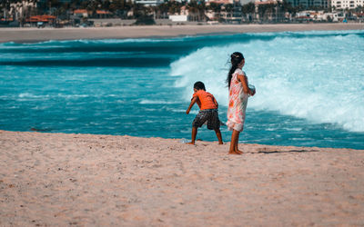 Rear view of couple on beach