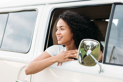 Portrait of smiling woman sitting in car