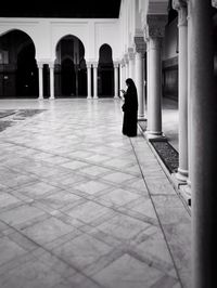 Woman walking in corridor of building