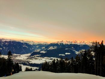 Scenic view of snowcapped mountains against sky during sunset