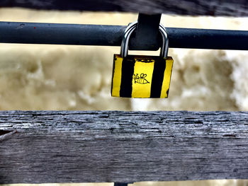 Close-up of padlocks hanging on railing