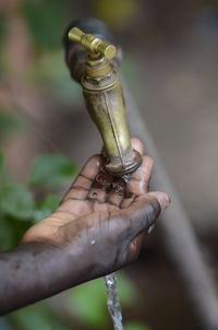 Close-up of human hand holding rusty metal