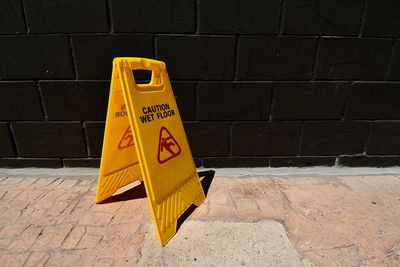 High angle view of yellow sign on wall