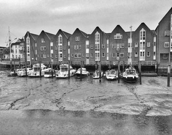 Boats in river with buildings in background