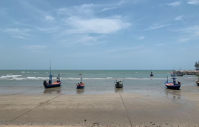 Boats moored on sea against sky