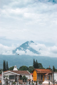 View of buildings and houses with a volcano background 