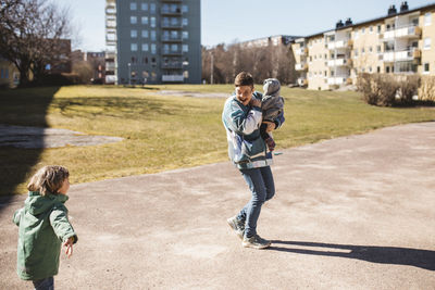 Mother walking with children