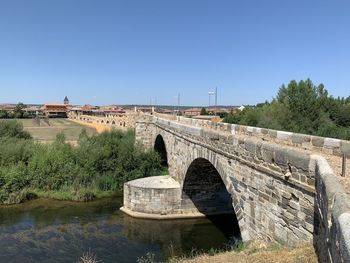 Bridge over river against clear sky