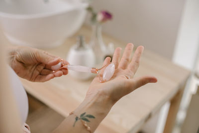 Cropped hand of woman holding jade roller