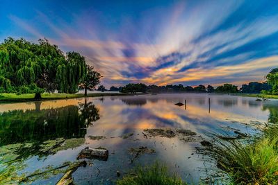 Scenic view of lake against sky at sunset