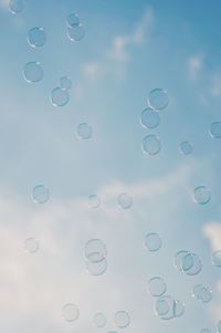 Close-up of bubbles in water against sky