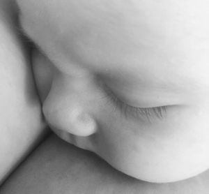 Midsection of young woman relaxing on bed