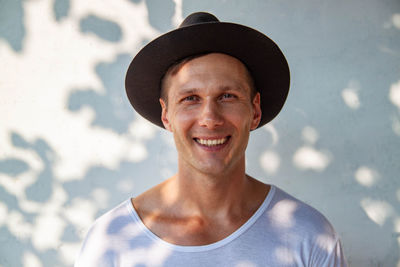 Portrait of young man wearing hat smilling to camera 