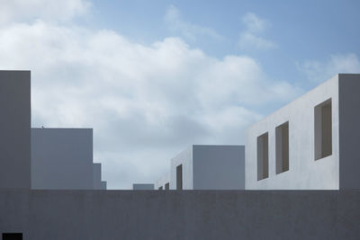 Low angle view of building against cloudy sky
