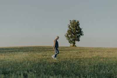 Man standing on field against clear sky